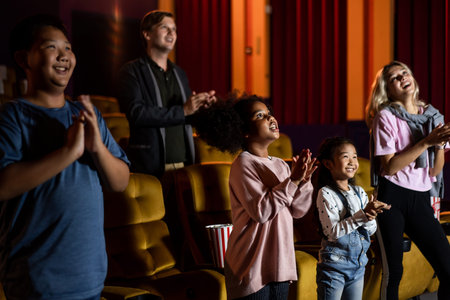 People audience watching movie in the movie theater cinema. Group recreation activity and...