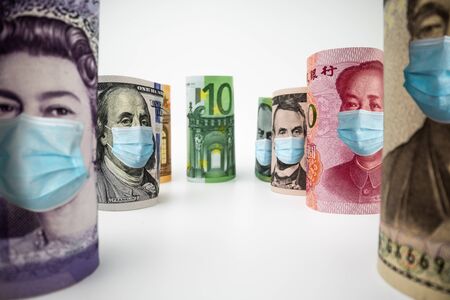 International currency money include US American Dollar, Euro Currency, British UK Pound, Australian Dollar, China Yuan and Japan Yen face mask concept of coronavirus disease COVID-19 economic crisis.の写真素材