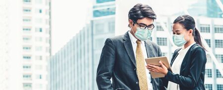 Office worker meeting with face mask quarantine from coronavirus or COVID-19. Concept of protective working environment to reopen business and stop spreading of coronavirus or COVID-19.の写真素材