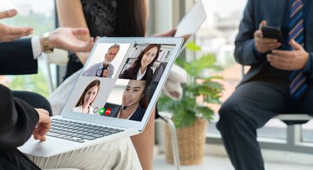 Video call group business people meeting on virtual workplace or remote office. Telework conference call using smart video technology to communicate colleague in professional corporate business.の写真素材