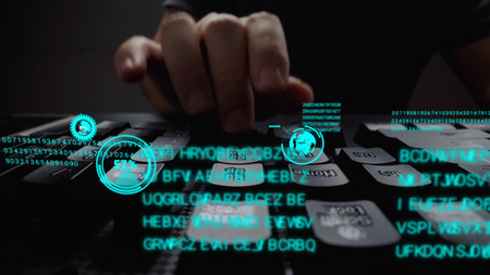 Man working on laptop computer keyboard with graphic user interface GUI hologram showing concepts of...