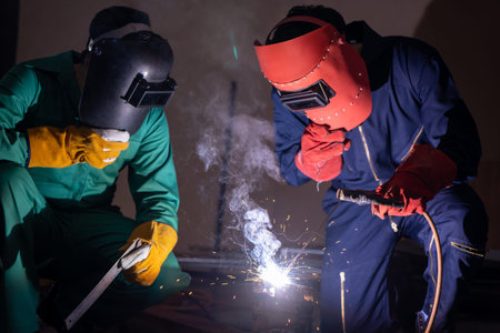 Metal welding steel works using electric arc welding machine to weld steel at factory. Metalwork...