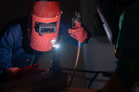Metal welding steel works using electric arc welding machine to weld steel at factory. Metalwork...