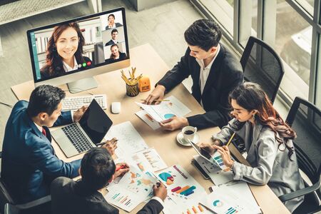 Video call group business people meeting on virtual workplace or remote office. Telework conference call using smart video technology to communicate colleague in professional corporate business.の写真素材