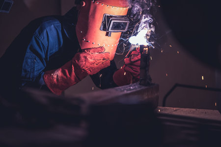 Metal welding steel works using electric arc welding machine to weld steel at factory. Metalwork...