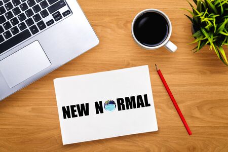 New normal concept effected by COVID 19 coronavirus that changes our lifestyle to new normal presented in word written in notebook on office desk when abnormal becomes new normal .の写真素材