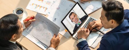 Video call group business people meeting on virtual workplace or remote office. Telework conference call using smart video technology to communicate colleague in professional corporate business.の写真素材