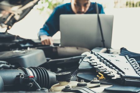 Professional mechanic providing car repair and maintenance service in auto garage. Car service business concept.の写真素材