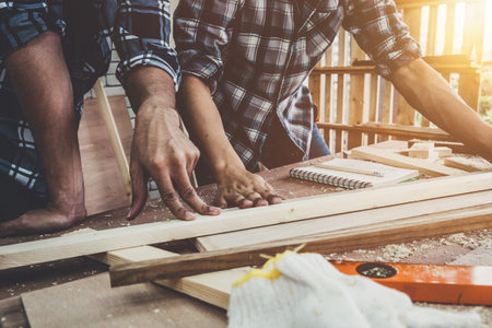 Carpenter working on wood craft at workshop to produce construction material or wooden furniture....
