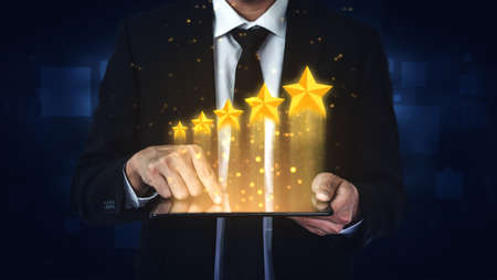 Customer review satisfaction feedback survey concept. User give rating to service experience on online application. Customer can evaluate quality of service leading to reputation ranking of business.の写真素材