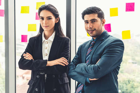 Successful business people standing together showing strong relationship of worker community. A team of businessman and businesswoman expressing a strong group teamwork at the modern office.の写真素材