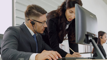 Business people wearing headset working in office to support remote customer or colleague. Call...