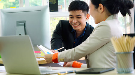 Two business people talk project strategy at office meeting room. Businessman discuss project...