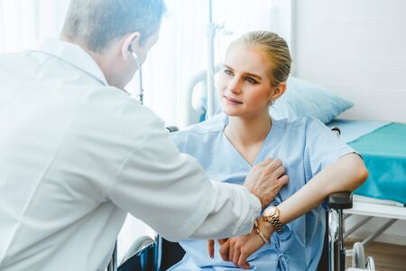 Doctor in professional uniform examining patient at hospital or medical clinic. Health care , medical and doctor staff service concept.の写真素材