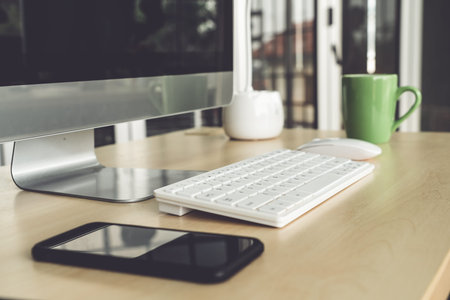 Close up keyboard desktop PC computer on table in small modern office or home office . Trendy...