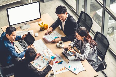 Business people group meeting shot from top view in office . Profession businesswomen, businessmen and office workers working in team conference with project planning document on meeting table .の写真素材