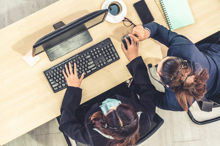 Business people wearing headset from top view in office working with computer to support remote...