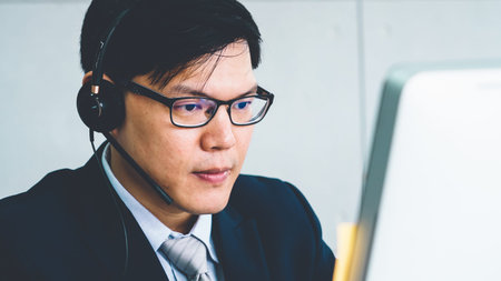 Business people wearing headset working in officeの写真素材