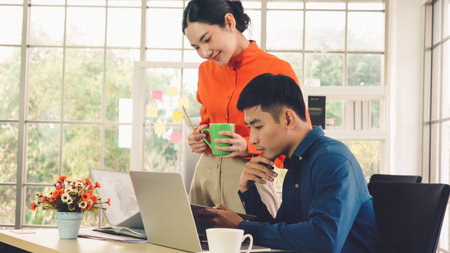 Two business people talk project strategy at officeの写真素材