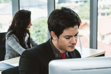 Business people working at table in modern officeの写真素材