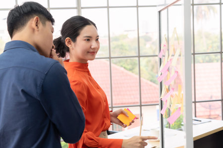 Business people work on project planning board