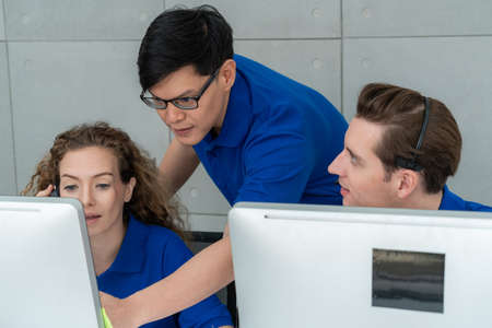 Business people wearing headset working in officeの写真素材