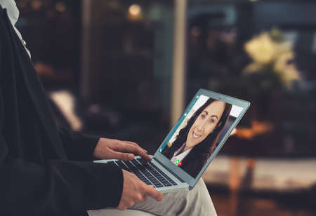 Video call business people meeting on virtual workplace or remote office. Telework conference call using smart video technology to communicate colleague in professional corporate business.の写真素材