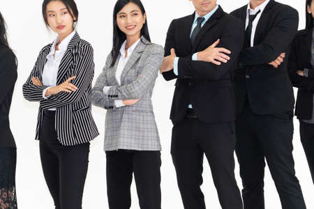 Successful business people standing together showing strong relationship of worker community. A team of businessman and businesswoman expressing a strong group teamwork at the modern office.の写真素材