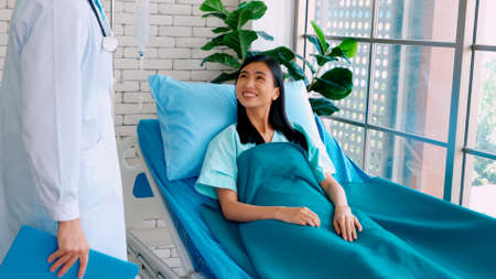 Doctor in professional uniform examining patient at hospital or medical clinic. Health care , medical and doctor staff service concept.の写真素材