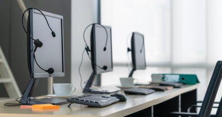 Call center computers and headsets all in office. Telemarketing, customer support agent provide service on telephone video conference call.の写真素材