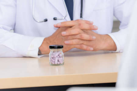 Doctor in professional uniform examining patient at hospital or medical clinic. Health care , medical and doctor staff service concept.の写真素材