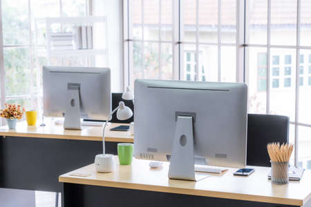 Desktop PC computers in small modern office or home office. Trendy workplace interior.の写真素材