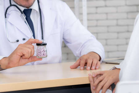 Doctor in professional uniform examining patient at hospital or medical clinic. Health care , medical and doctor staff service concept.の写真素材