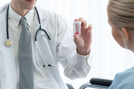 Doctor in professional uniform examining patient at hospital or medical clinic. Health care , medical and doctor staff service concept.の写真素材