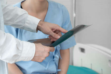 Doctor in professional uniform examining patient at hospital or medical clinic. Health care , medical and doctor staff service concept.の写真素材