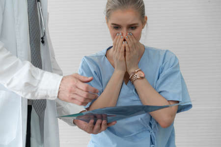 Doctor and unhappy patient at hospital or medical clinic . Healthcare medical malpractice and failure concept.の写真素材