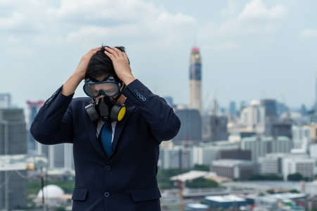 Unhappy lost business man with face mask protect from Coronavirus or Covid-19 suffers economic recession trouble. Concept of unemployment problem crisis caused by pandemic of Coronavirus Covid-19.の写真素材
