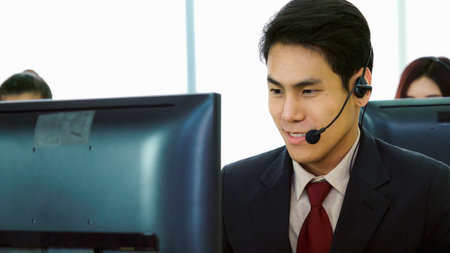 Business people wearing headset working in office to support remote customer or colleague. Call...
