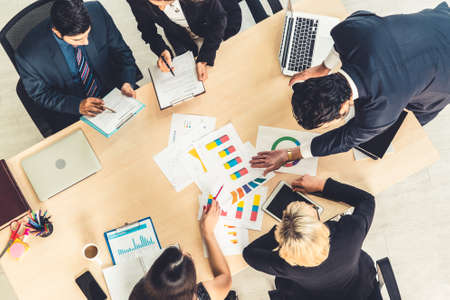 Business people group meeting shot from top view in office . Profession businesswomen, businessmen and office workers working in team conference with project planning document on meeting table .の写真素材
