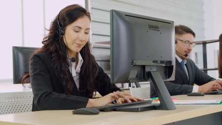 Business people wearing headset working in office to support remote customer or colleague. Call...