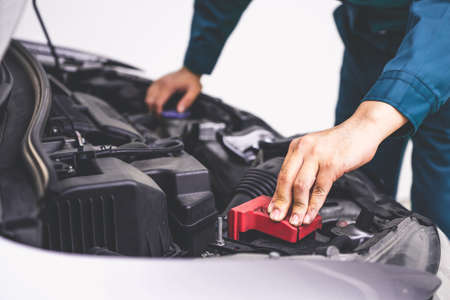 Professional mechanic hand providing car repair and maintenance service in auto garage. Car service business concept.の写真素材