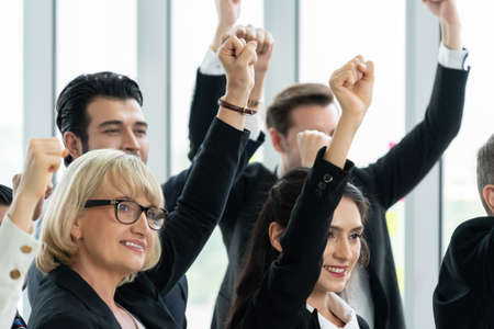 Successful business people standing together showing strong relationship of worker community. A team of businessman and businesswoman expressing a strong group teamwork at the modern office.の写真素材