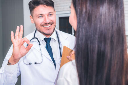 Doctor in professional uniform examining patient at hospital or medical clinic. Health care , medical and doctor staff service concept.の写真素材