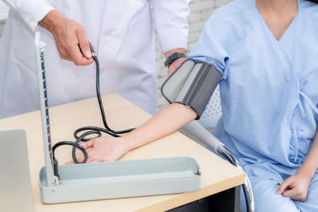 Doctor in professional uniform examining patient at hospital or medical clinic. Health care , medical and doctor staff service concept.の写真素材