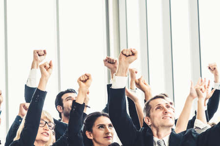 Successful business people standing together showing strong relationship of worker community. A team of businessman and businesswoman expressing a strong group teamwork at the modern office.の写真素材
