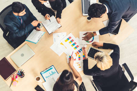 Business people group meeting shot from top view in office . Profession businesswomen, businessmen and office workers working in team conference with project planning document on meeting table .の写真素材