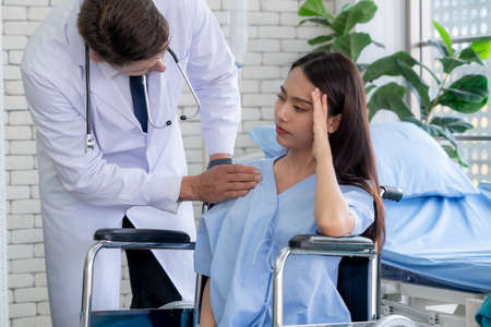 Doctor in professional uniform examining patient at hospital or medical clinic. Health care , medical and doctor staff service concept.の写真素材