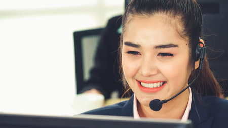 Business people wearing headset working in office to support remote customer or colleague. Call...