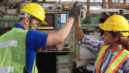 Group of factory workers using machine equipment in factory workshop . Industry and engineering...