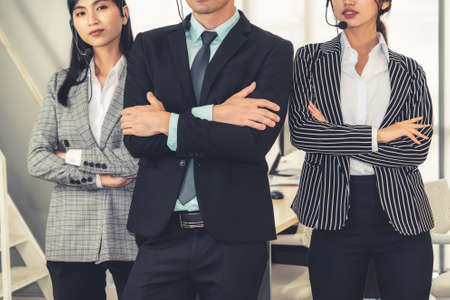 Business people wearing headset working in office to support remote customer or colleague. Call center, telemarketing, customer support agent provide service on telephone video conference call.の写真素材